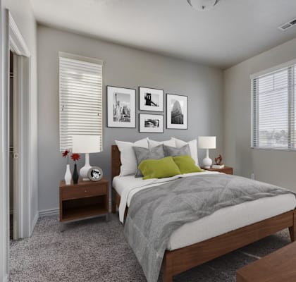 a bedroom with a bed and two nightstands and a window