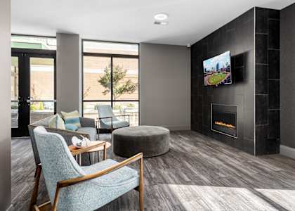 a living room with a fireplace and a tv at Hibernia Apartments, St Louis, Missouri