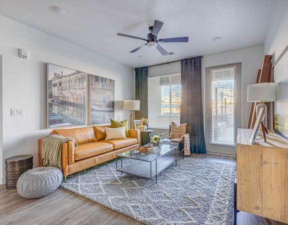 a living room with a couch coffee table and large windows
