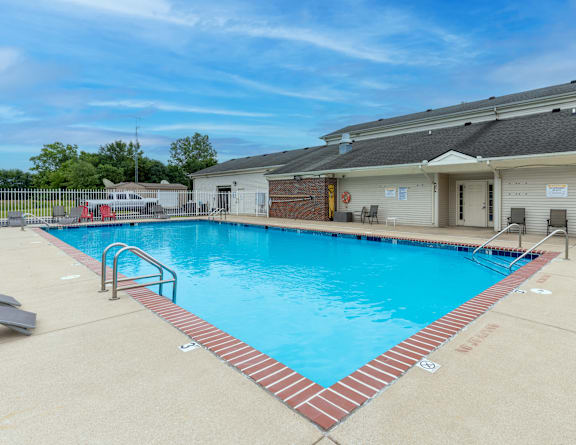our resort style swimming pool is next to our building with lounge chairs