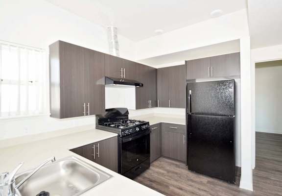 a kitchen with black appliances and white countertops