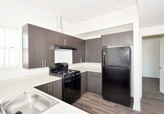 a kitchen with black appliances and white countertops