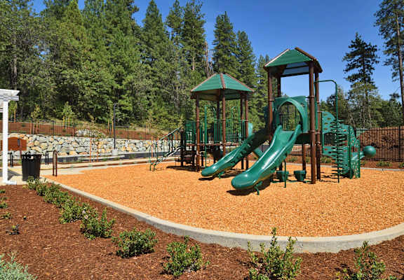 a playground with two slides and a jungle gym
