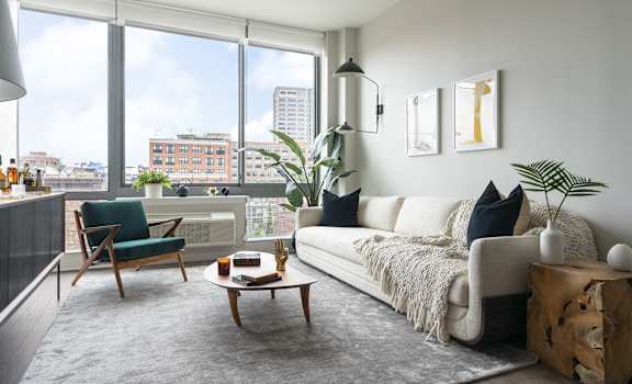 a living room with a white couch and a large window