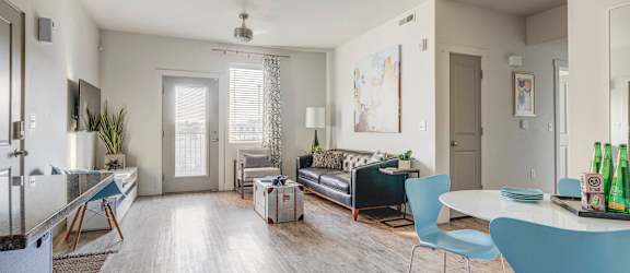 a living room with a couch and a dining room table
