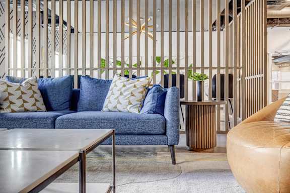 a living room with a blue couch and a coffee table