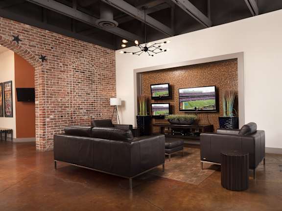 A living room with a brick wall and a couch  at Bristol Station Apartments, Carteret, New Jersey