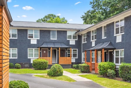 the front of an apartment building with a sidewalk in front of it at Gardens at Washington Park in Atlanta, GA 30314