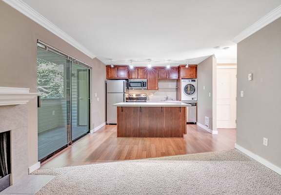 A kitchen with wooden cabinets and a white fridge.