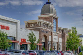 a building with a large dome on top and a parking lot