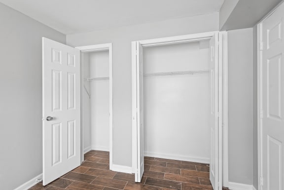 an empty room with two closets and a door