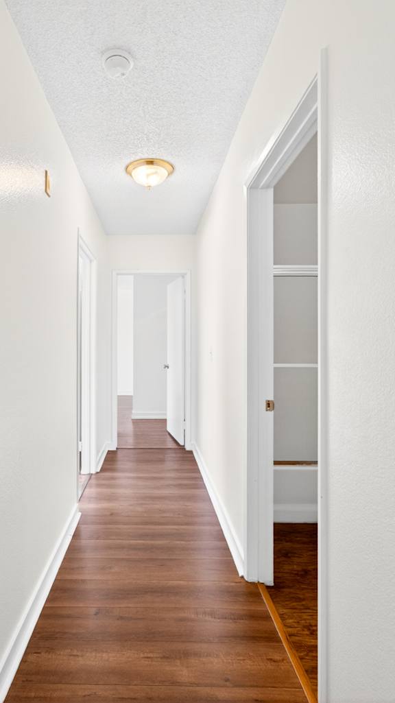 A room with a trash can and a door.