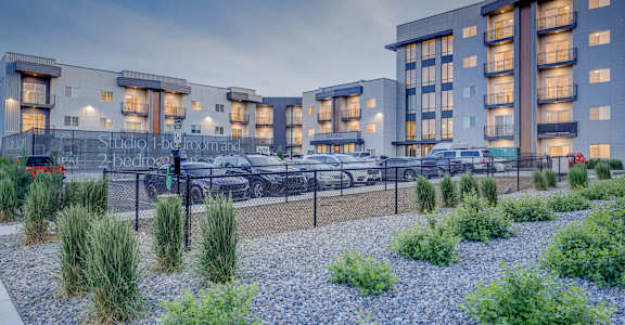A modern building with a parking lot in front of it.