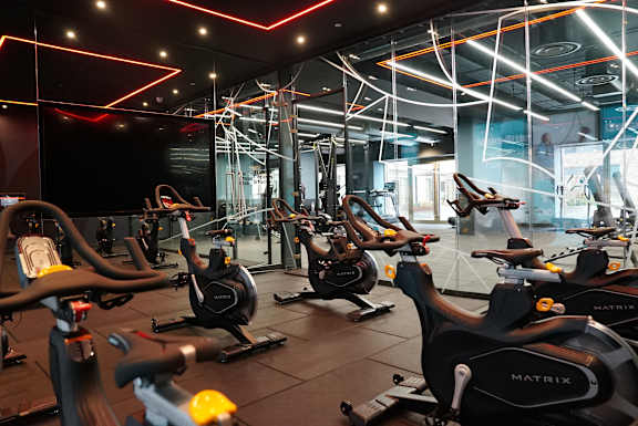 a gym with various exercise bikes in it