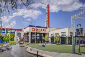a rendering of a cinema with a fountain in front of it