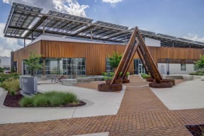 a building with a triangular sculpture in front of it