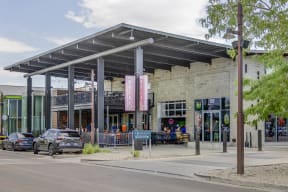 the facade of a building with cars parked in front of it