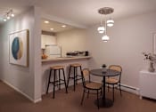 Thumbnail 5 of 8 - A small dining area with a round table and four chairs.
