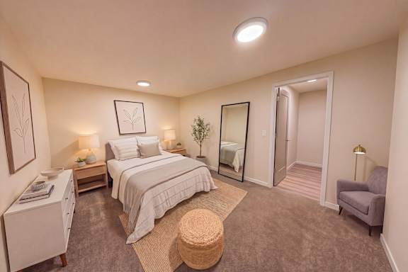 A bedroom with a large bed and a chair.