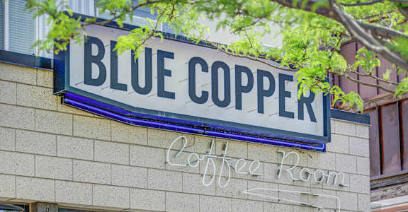 a sign on the front of a building that reads blue copper