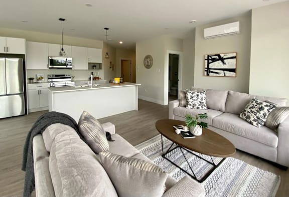 A modern living room with a grey sofa and a coffee table.