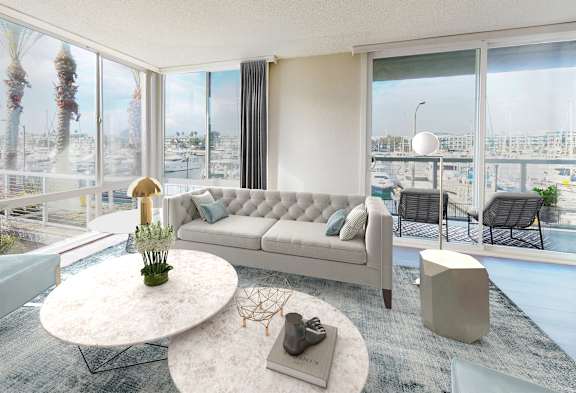 A modern living room with a large window overlooking a marina.
