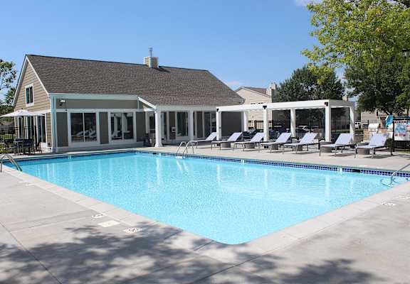 A large swimming pool with a building in the background.
