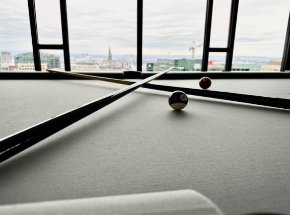 a pool table with a view of the city
