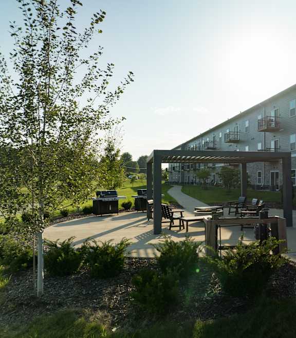 A modern apartment complex with a courtyard and seating area.