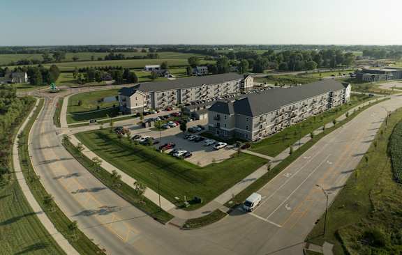 A large building with a parking lot in front of it.