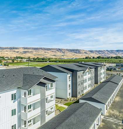 an aerial view of apartment buildings with mountains in the background at Gateway Apartments, East Wenatchee ,Washington, 98802