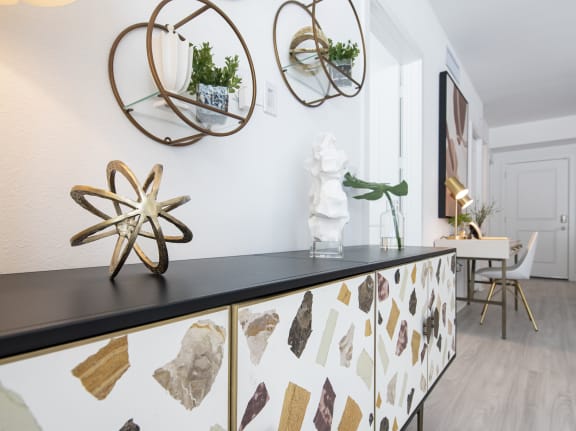 a living room with a piece of artwork on the wall