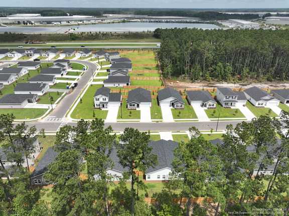 A bird's eye view of a residential area with houses and cars.