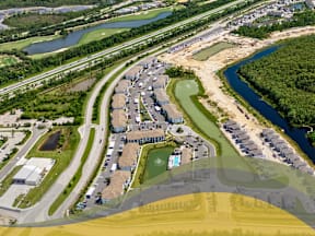 Bird's eye view of a residential area with houses and a river2 at Portofino Vineyards, Fort Myers, FL, 33967