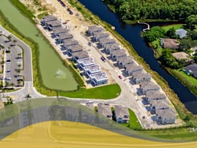 Bird's eye view of a residential area with houses and a river3 at Portofino Vineyards, Fort Myers, FL