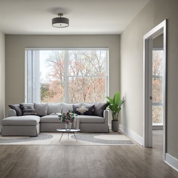 a living room with a couch in front of a window