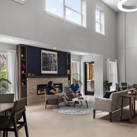 a rendering of a living room with a fireplace and people in it