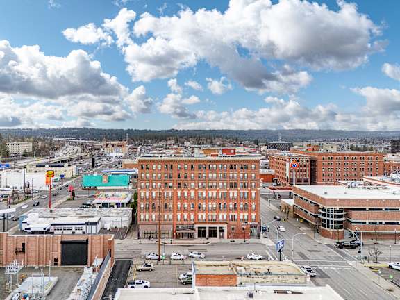 A cityscape with a large building in the center and cars on the road at 206 Flats, Spokane, WA 99201