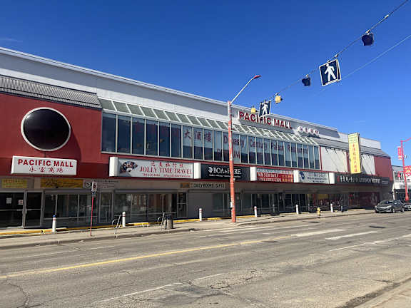 A large red building with a white sign that says Pacific Mall.