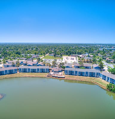 an aerial view of the lake and buildings in the city
