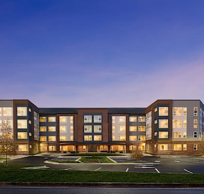 the building where the hotel is located is lit up at dusk