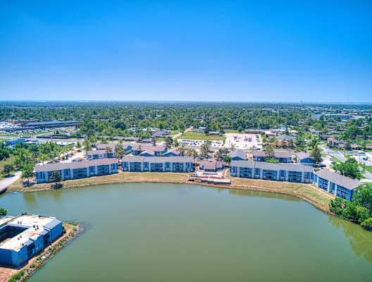 an aerial view of the lake and buildings in the city at Diamond Lake Apartments, Oklahoma City, 73122