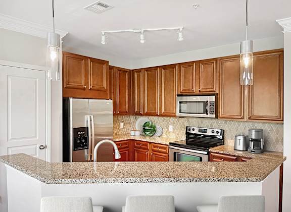 A kitchen with wooden cabinets and granite countertops.
