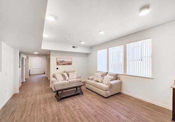 the living room of a home with two couches and a table