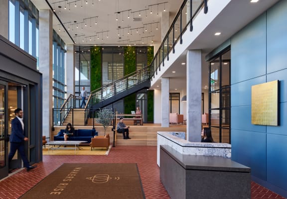 the lobby of a large office building with a lobby area and stairs