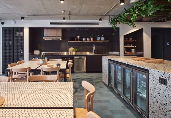 the kitchen and dining area of a modern restaurant with a table and chairs