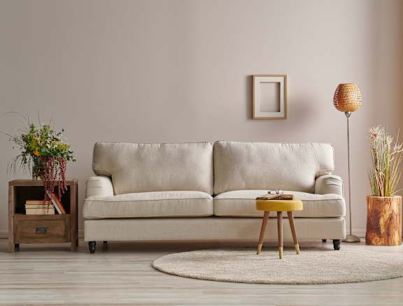A modern living room with a large circular table in the center.