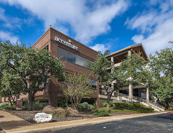 a brick office building with trees in front of it