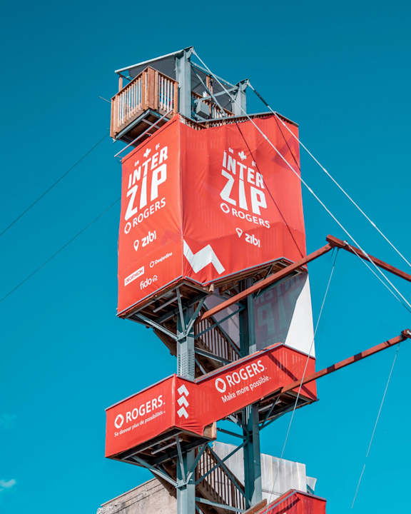 A tall structure with multiple red boxes stacked on top of each other, each box has the Rogers logo and the words "Inter Zip" on it.
