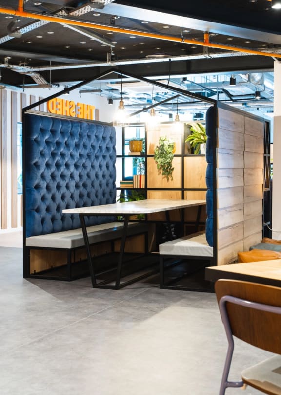 a booth in a restaurant with a table and chairs